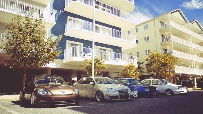 Volkswagen Beetle and Jetta cars parked by buildings