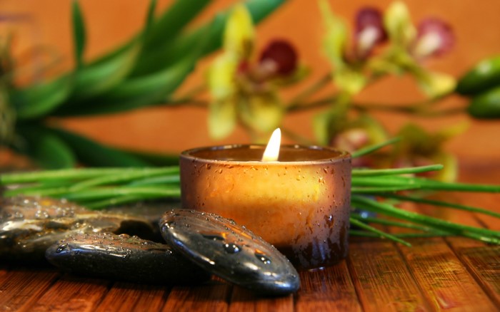 Spa candle with stones and orchids