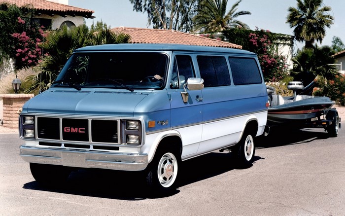 1985 GMC Vandura Rally STX towing a boat