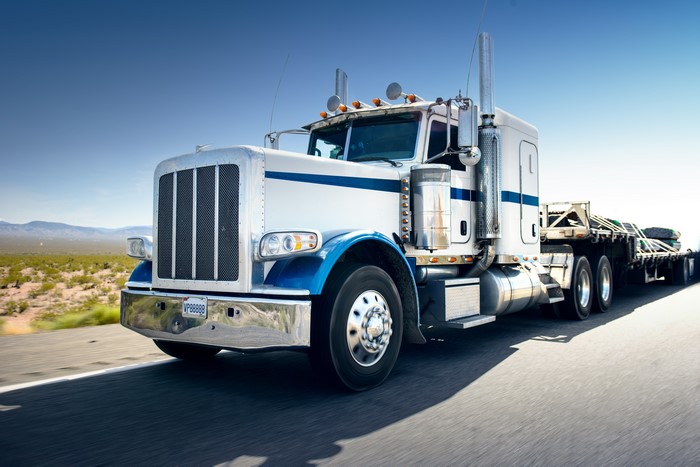 White Semi-Truck with Trailer on Highway