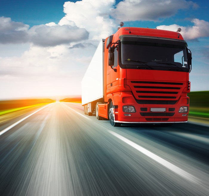 Red Truck Driving on Highway