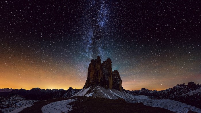 Milky Way over Tre Cime di Lavaredo mountains at night