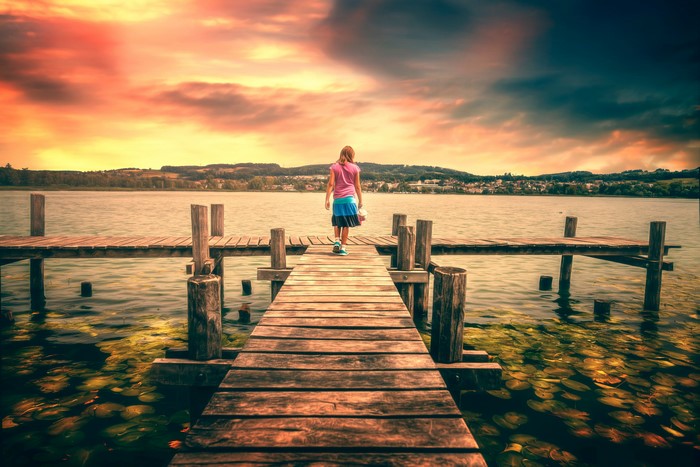 Girl on a dock at sunset