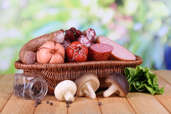 Sausages and mushrooms in a wicker basket