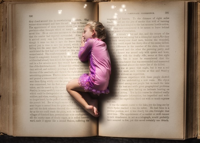 Girl sleeping on an open book