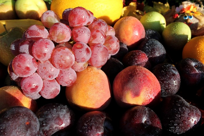 Grapes, Peaches, Plums, and other fruits with water droplets