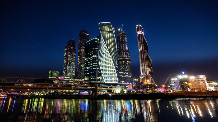 Moscow skyscrapers at night reflected in the river