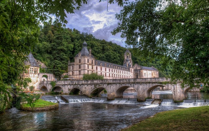 Abbey of Brantome and bridge over the Dordogne River, France