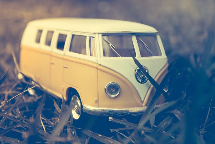 Yellow and white toy Volkswagen bus in grass