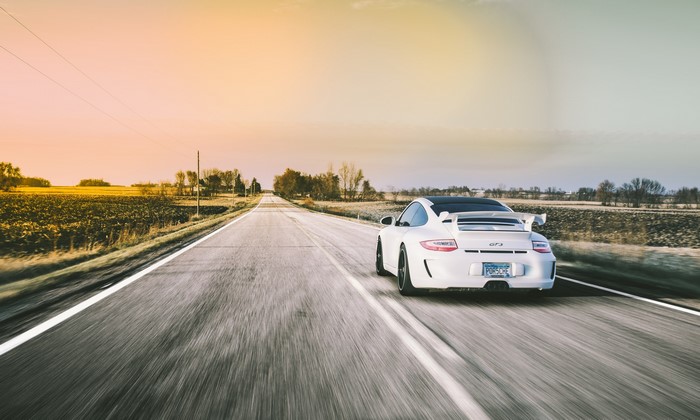 White Porsche 911 GT3 driving on a rural road