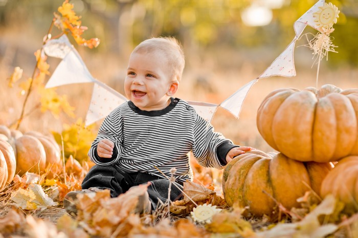 Baby Boy with Pumpkins and Autumn Leaves
