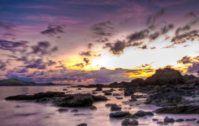 Rocky Shoreline at Sunset with Dramatic Clouds