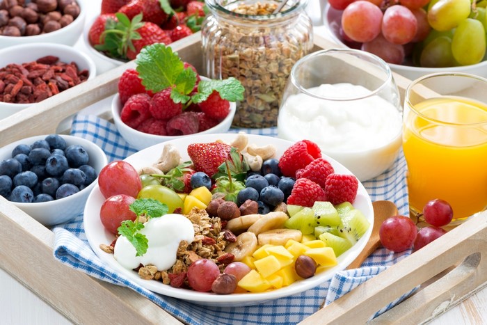 Healthy breakfast with fruits, yogurt, granola, and juice
