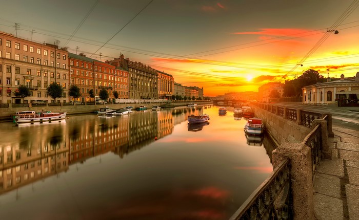 St. Petersburg canal at sunset with boats