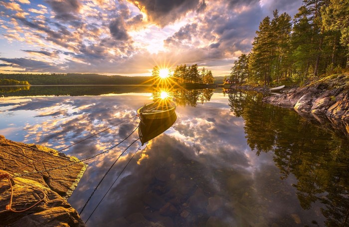 Boat on a lake at sunrise in Ringerike, Norway