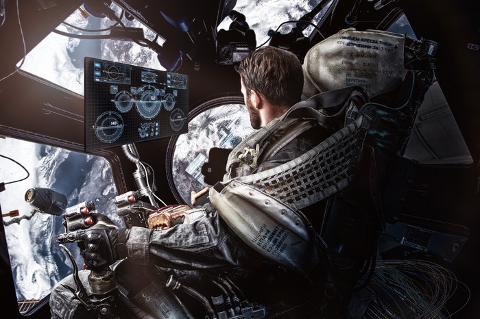 Astronaut in a spaceship cockpit overlooking Earth