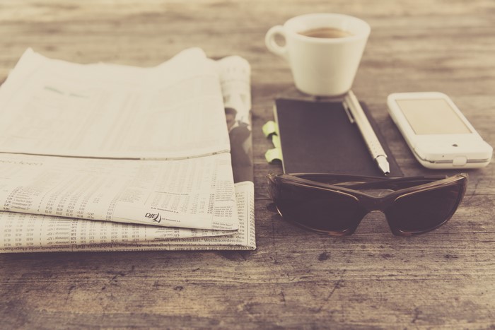 Newspaper, Coffee, Sunglasses, Notebook, Pen, and Phone