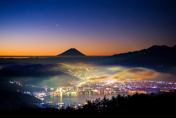Mount Fuji and city lights at dusk, Japan