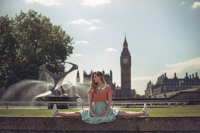 Woman doing splits in front of Big Ben and fountain