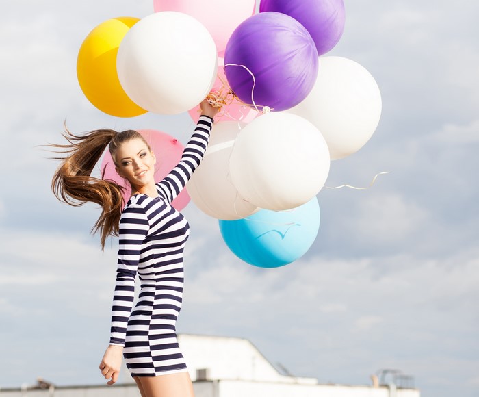 Woman holding colorful balloons