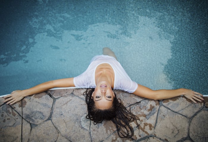 Woman in wet t-shirt in a pool