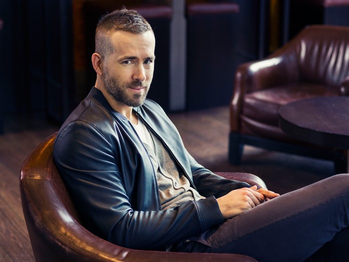 Ryan Reynolds sitting in a leather chair