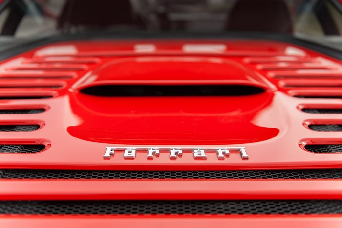 Close-up of a red Ferrari car emblem