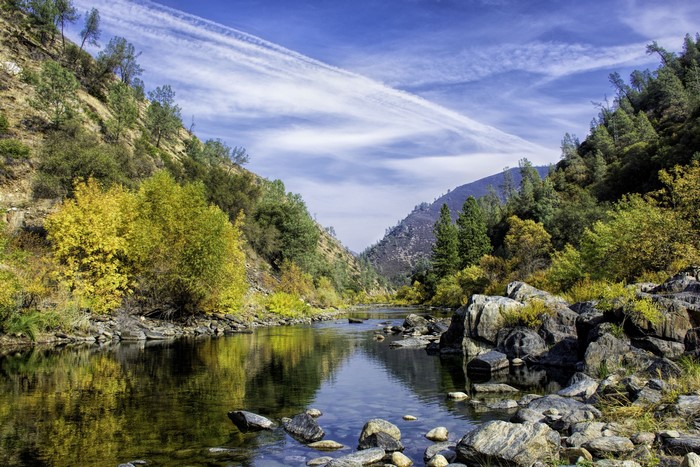River flowing through a mountain valley in autumn