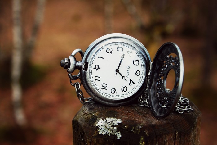 Pocket watch on a wooden post