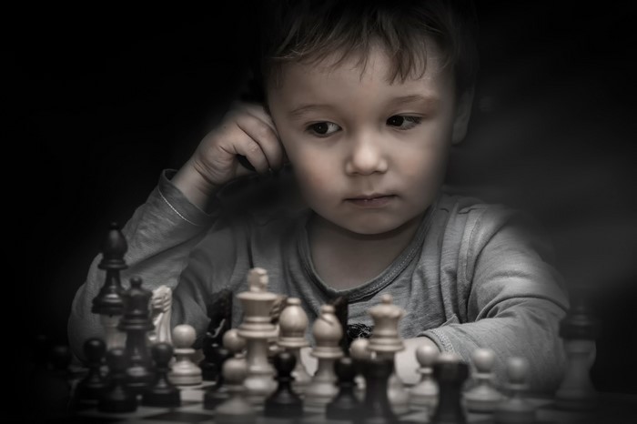 Young boy playing chess