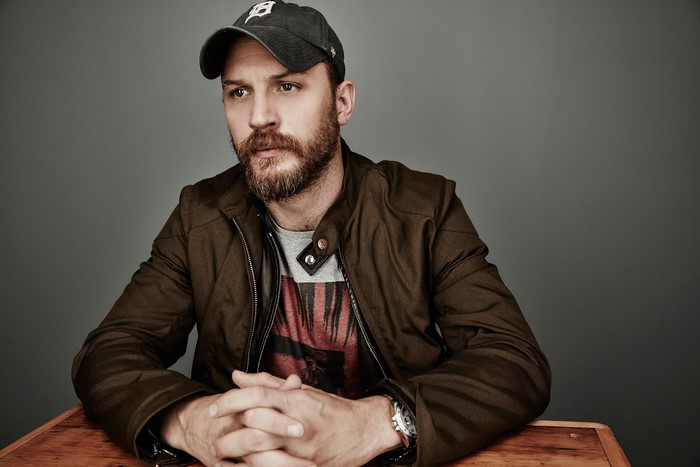 Tom Hardy wearing a baseball cap and jacket