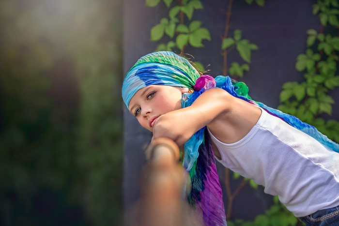 Girl with colorful headscarf looking away