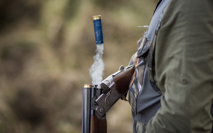 Shotgun cartridge ejecting with smoke