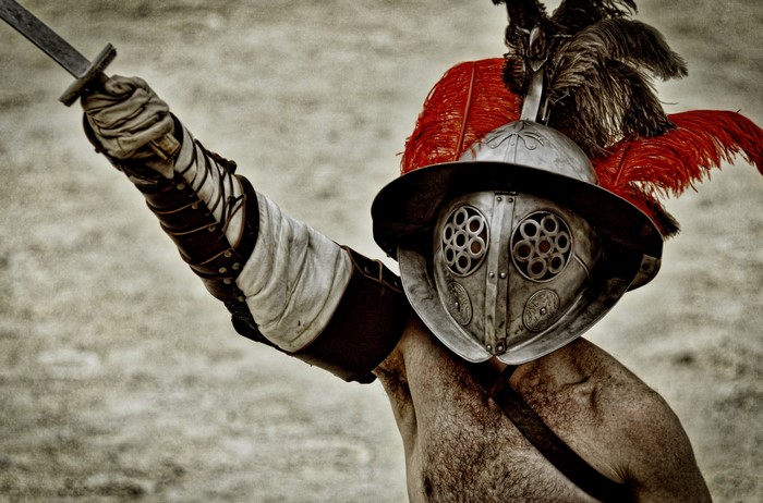 Gladiator in armor with sword and helmet