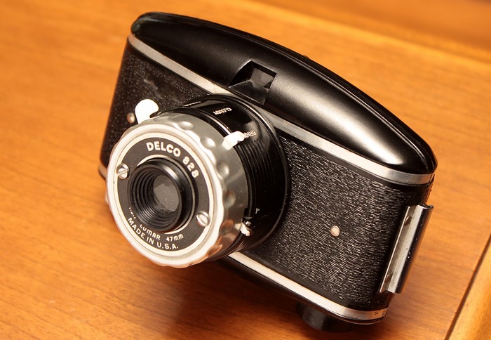 Delco 828 retro camera on wooden table