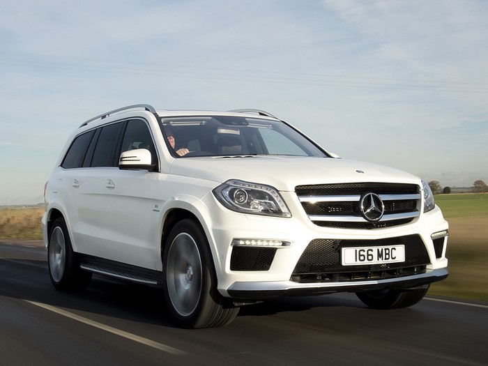 White Mercedes-Benz GL 63 AMG driving on a road