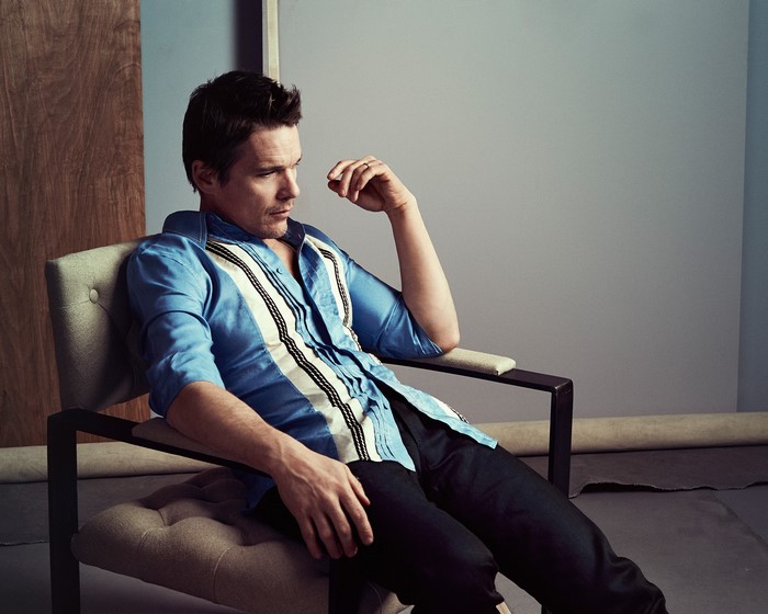 Ethan Hawke sitting in a chair
