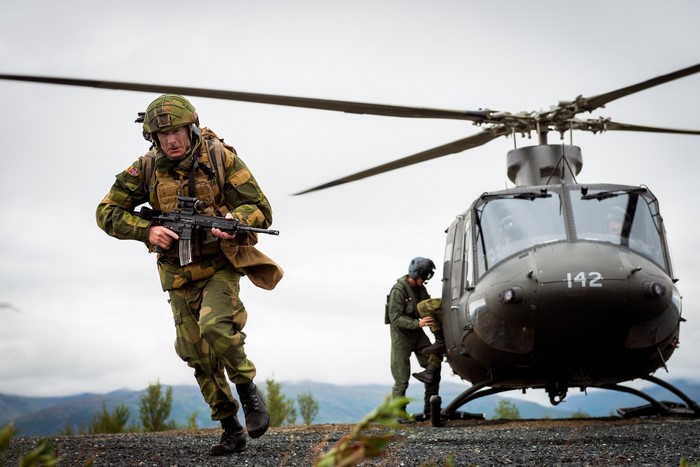 Norwegian soldiers disembarking from a helicopter