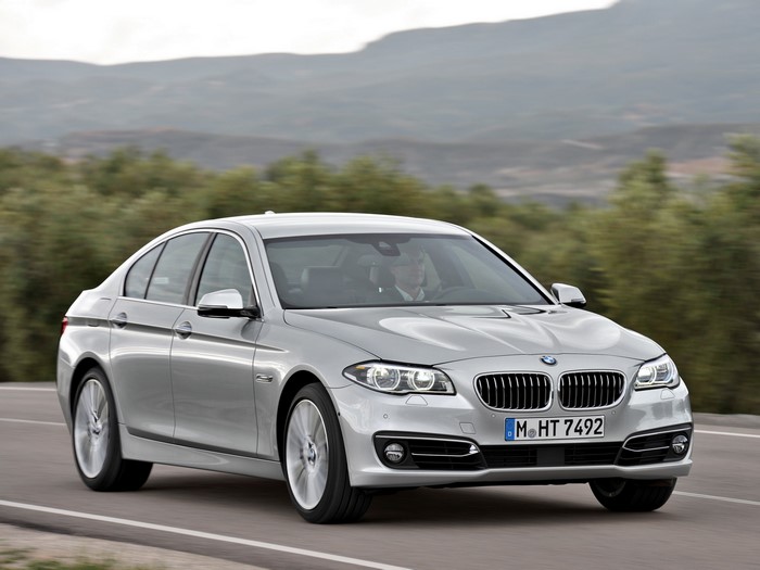 Silver BMW 535i Sedan Luxury Line driving on a road