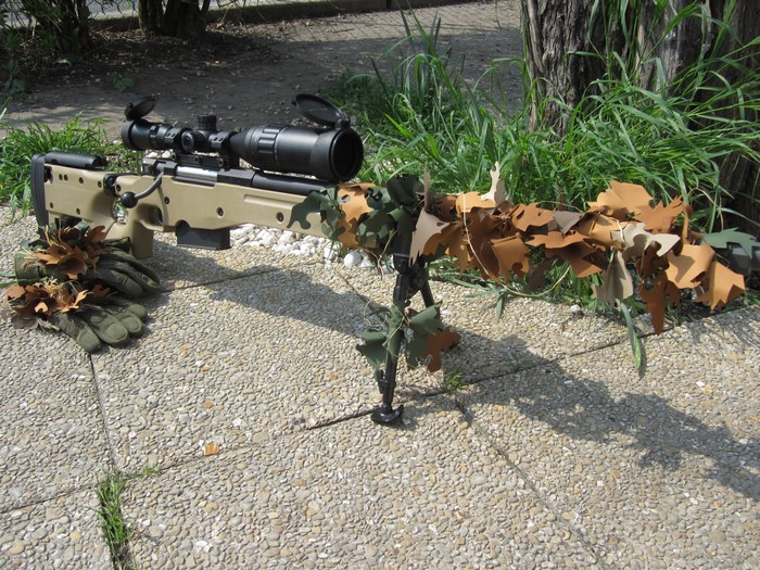 Sniper rifle with camouflage