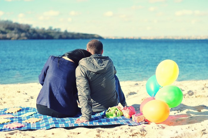 Couple on a beach with balloons