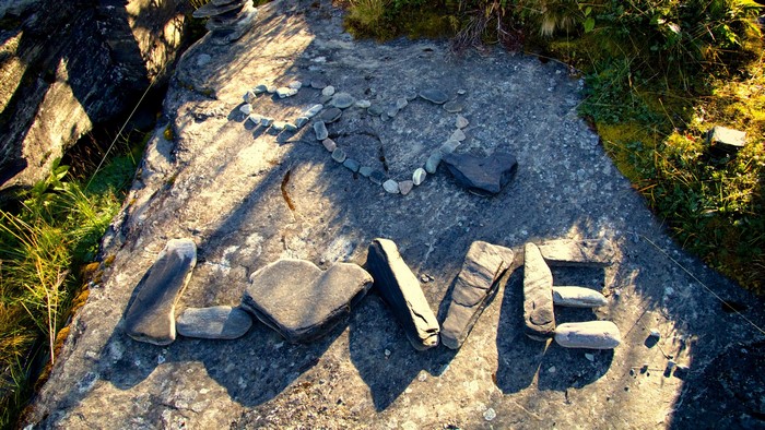 Love spelled with stones on a rock
