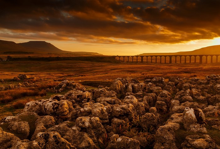 Stone Viaduct in a Rural Landscape at Sunset