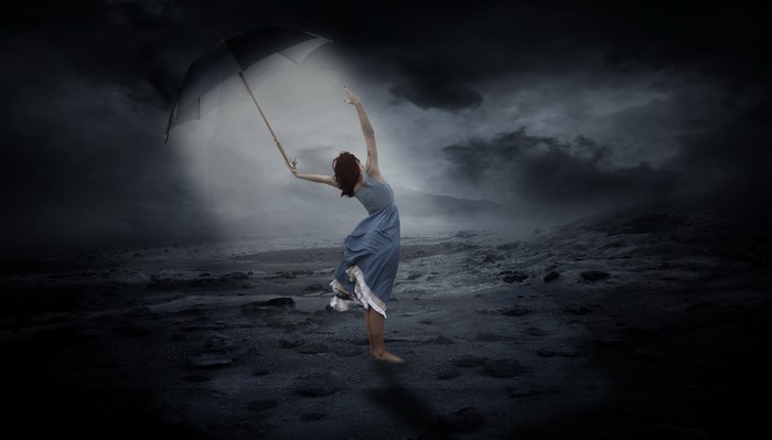 Woman with umbrella in stormy night
