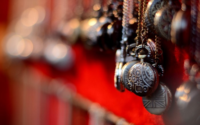 Pocket watches with chains on red background
