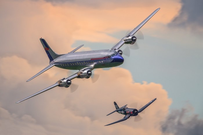 Vintage airliner and fighter plane in flight