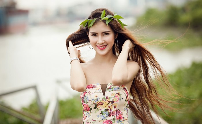Model Quyen with long brown hair and a floral dress