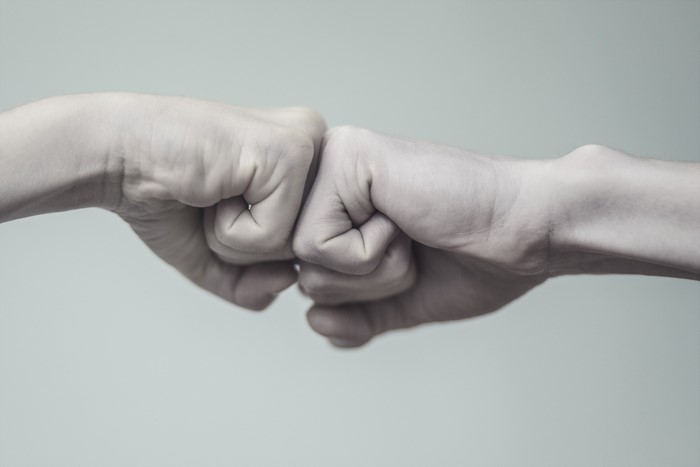 Two fists bumping