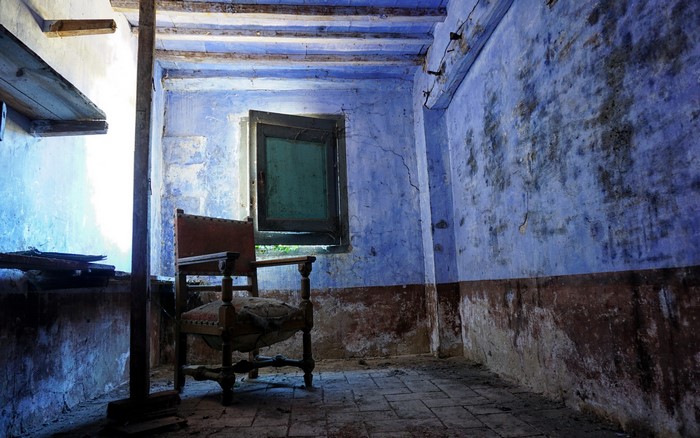 Old chair in a room with a window