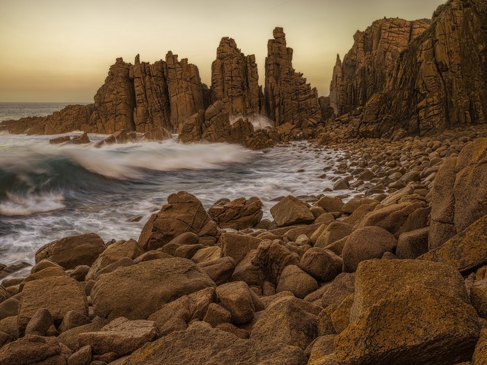 Rocky coastline with waves crashing against stone formations